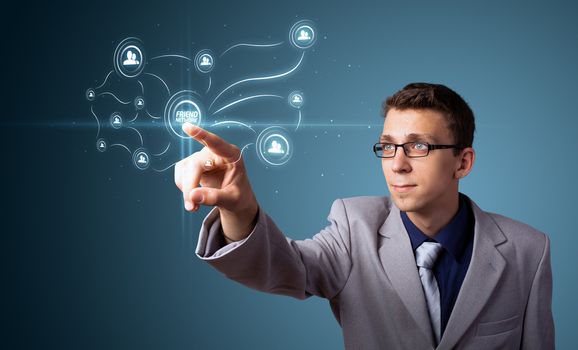 Businessman pressing modern social buttons on a virtual background