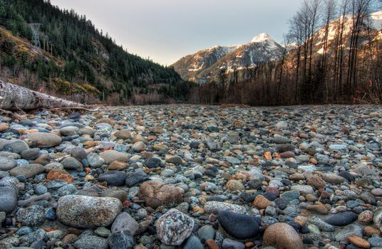 Field of natural stones with mountains and forest in background