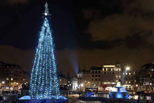 LONDON - DECEMBER 18: The Christmas tree on Trafalgar Square is illuminated with blue lights on December 18, 2012 in London, UK. Since 1947 the pine tree has been a gift from Norway.