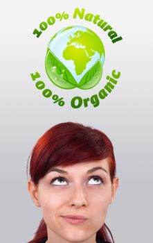 Young girl head looking at green eco sign
