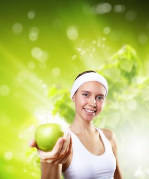 Young pretty girl in sport wear with green apple