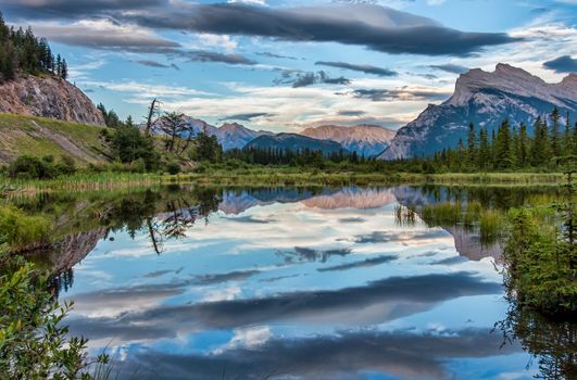 Reflection of dramatic dark clouds in Vermilion Lake outside of the town of Banff.