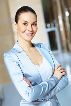 Portrait of happy smiling young businesswoman in office