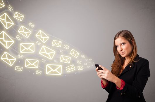 attractive young lady standing and holding a phone with message icons