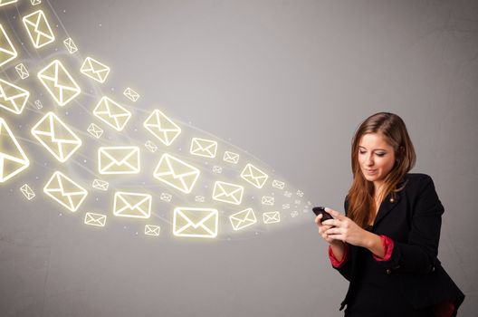 attractive young lady standing and holding a phone with message icons