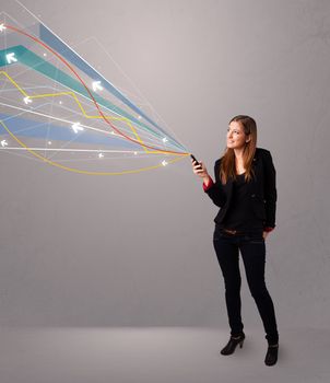 pretty young lady standing and holding a phone with colorful abstract lines and arrows