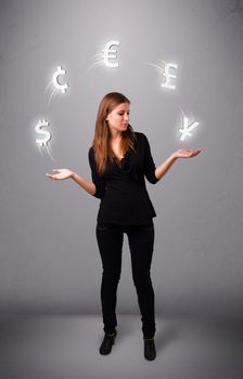 pretty young lady standing and juggling with currency icons