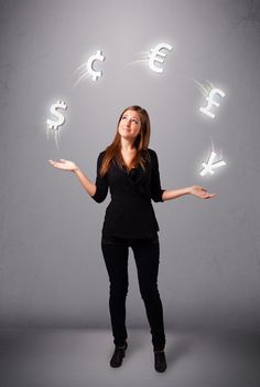 pretty young lady standing and juggling with currency icons