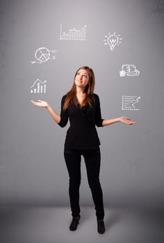beautiful young woman standin and juggling with statistics and graphs