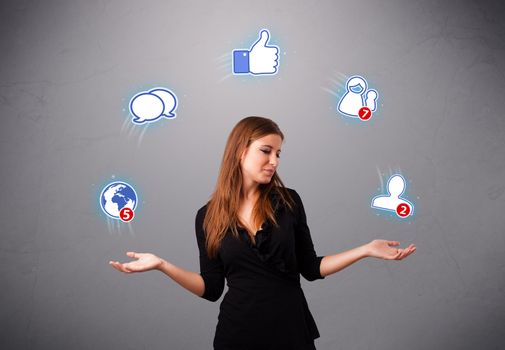 attractive young woman standing and juggling with social network icons