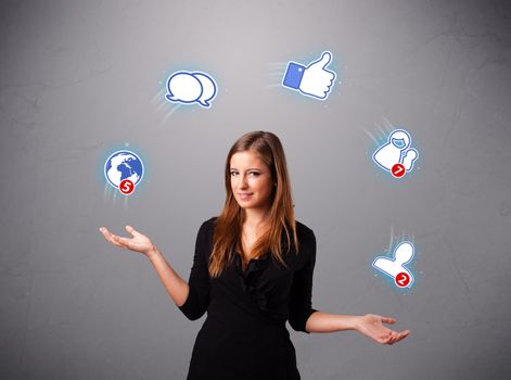 attractive young woman standing and juggling with social network icons