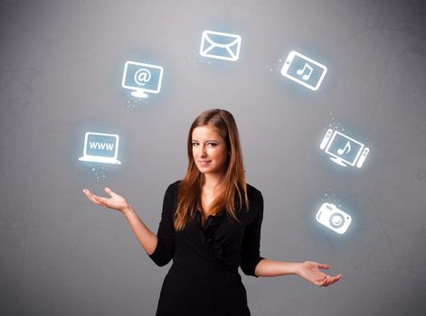 pretty girl standing and juggling with elecrtonic devices icons
