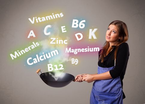 Pretty young woman cooking vitamins and minerals