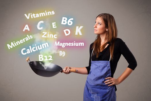 Pretty young woman cooking vitamins and minerals