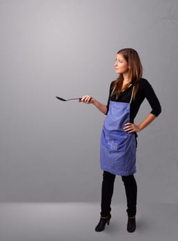 Beautiful young woman holding a spoon