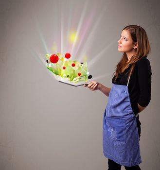 Beautiful young woman cooking fresh vegetables with abstract lights