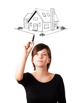 Young woman drawing a house on whiteboard isolated on white