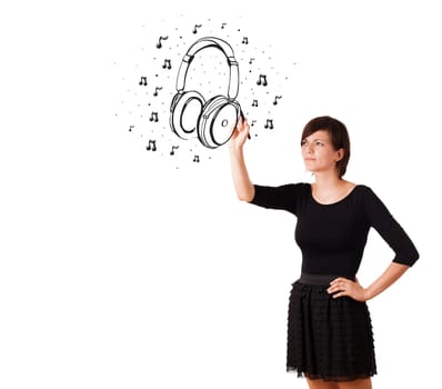 Young girl drawing headphone and musical notes isolated on white