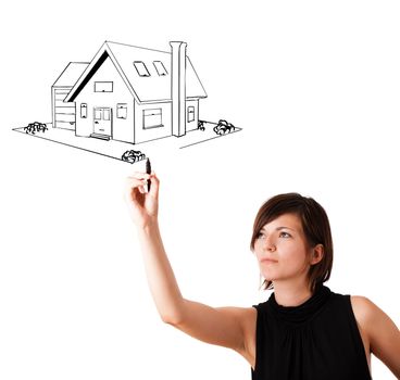 Young woman drawing a house on whiteboard isolated on white