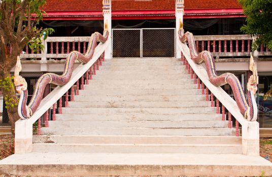 The Serpent statue on the ladder at the entrance to Thai temple.