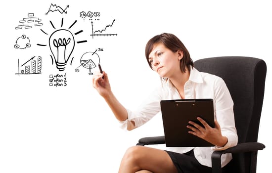 Young business woman drawing light bulb with various diagrams and charts on whiteboard isolated on white