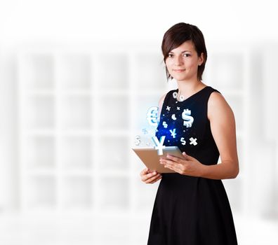 Young business woman looking at modern tablet with currency icons