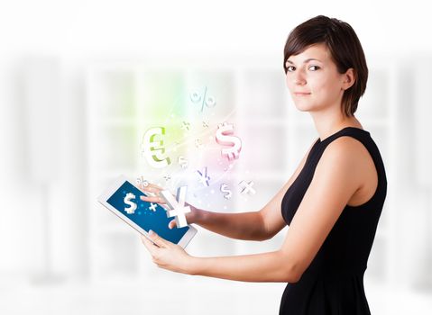 Young business woman looking at modern tablet with currency icons