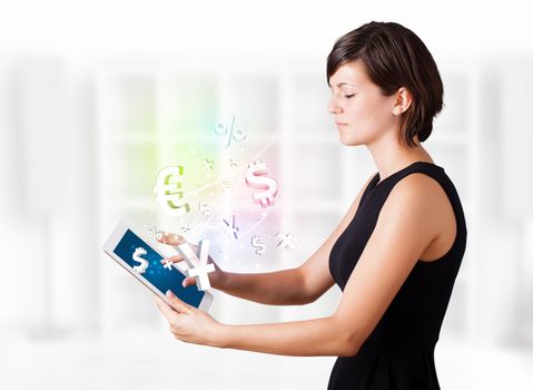 Young business woman looking at modern tablet with currency icons