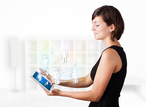 Young business woman looking at modern tablet with social icons