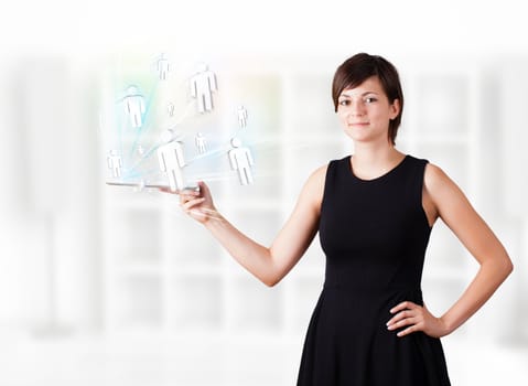 Young business woman looking at modern tablet with social icons