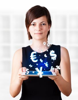 Young business woman looking at modern tablet with currency icons