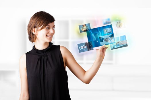 Young business woman browsing pictures on modern tablet