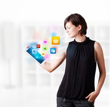 Young business woman looking at modern tablet with colourful icons