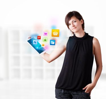 Young business woman looking at modern tablet with colourful icons
