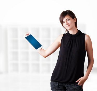 Young business woman looking at modern tablet