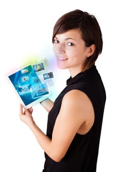 Young business woman browsing pictures on modern tablet