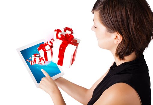 Young business woman looking at modern tablet with present boxes