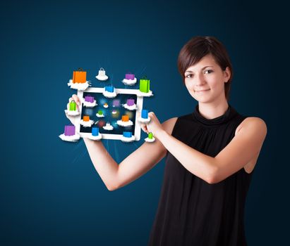 beautiful woman holding modern tablet with colorful shopping bags on clouds