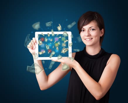 beautiful young woman holding tablet with money