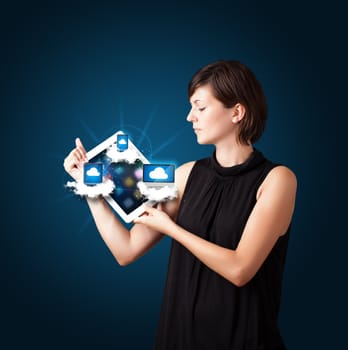 Beautiful young woman holding tablet with modern devices in clouds