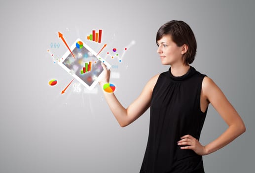 beutiful woman holding modern tablet with colorful diagrams and graphs