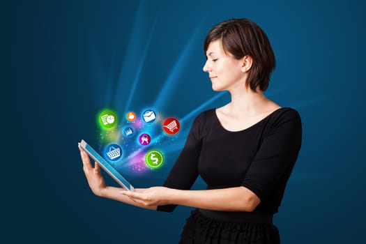 Young business woman looking at modern tablet with abstract lights and various icons