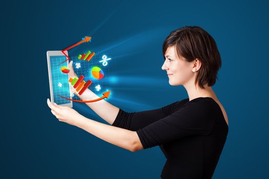 Young business woman looking at modern tablet with abstract lights and various diagrams