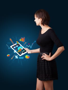 beutiful woman holding modern tablet with colorful diagrams and graphs