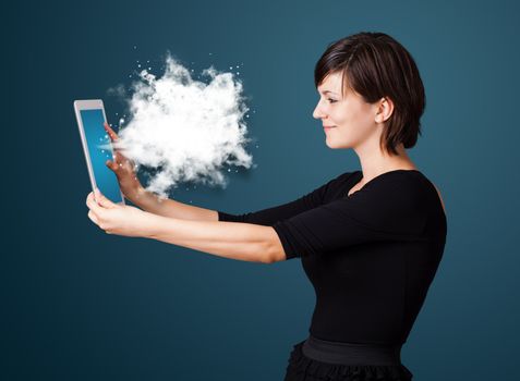 Young business woman looking at modern tablet with abstract cloud