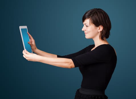 Young business woman looking at modern tablet 