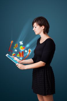 Young business woman looking at modern tablet with abstract lights and various diagrams