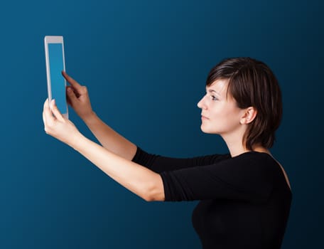 Young business woman looking at modern tablet 