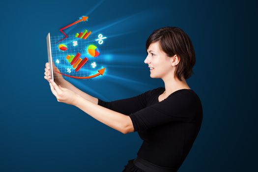 Young business woman looking at modern tablet with abstract lights and various diagrams