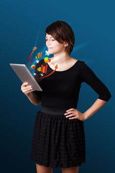 Young business woman looking at modern tablet with abstract lights and various diagrams